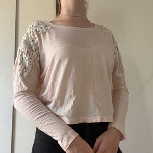 Pink shirt with white lace detailing on shoulders
